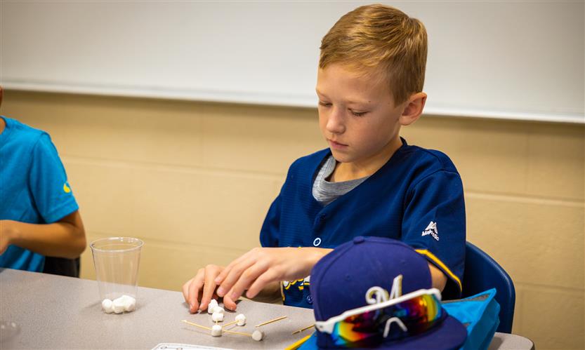 Students make constellations out of marshmallows and toothpicks